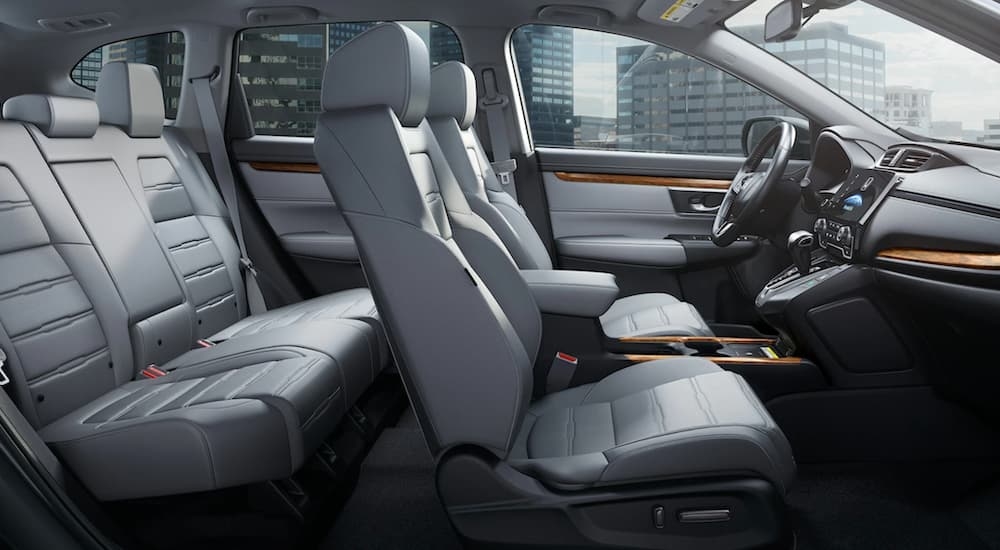 The white interior of a 2022 Honda CR-V is shown from the passenger side.