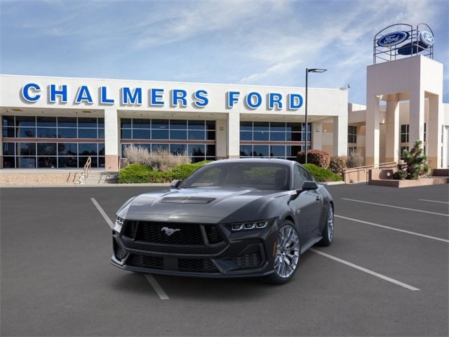 black 2024 Ford Mustang muscle car parked at the Chalmers Ford dealership in Albuquerque, NM