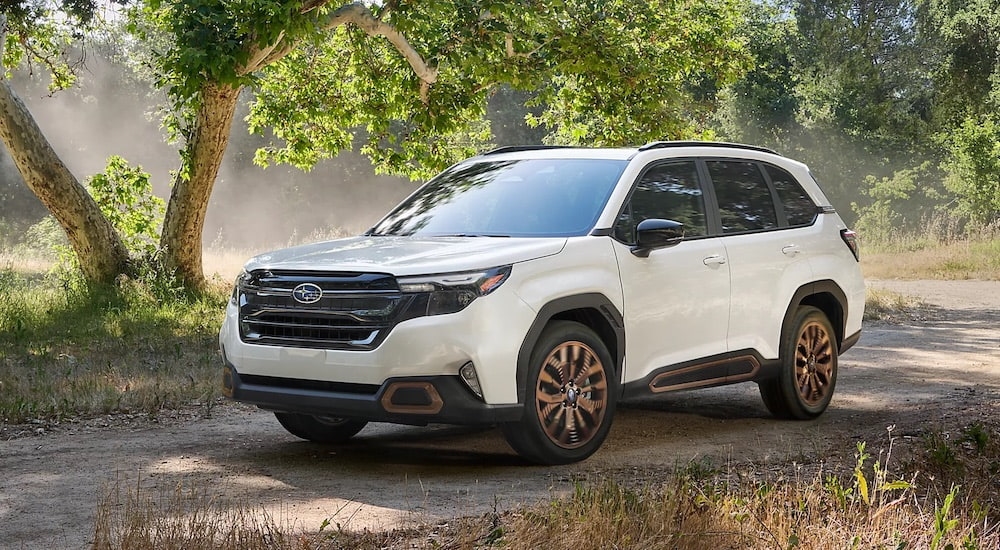 A white 2025 Subaru Forester for sale near Poughkeepsie driving on a trail.