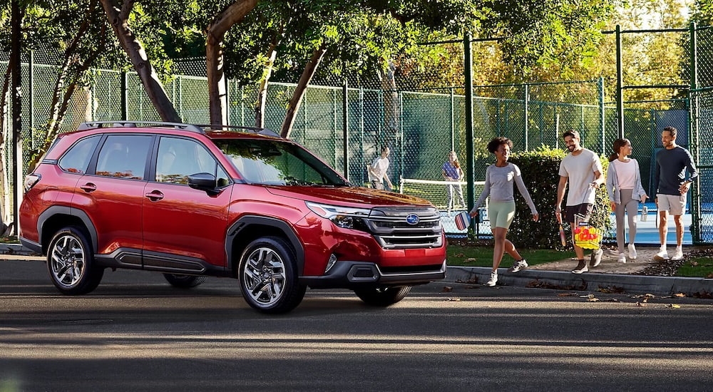 A red 2025 Subaru Forester is shown from the side.