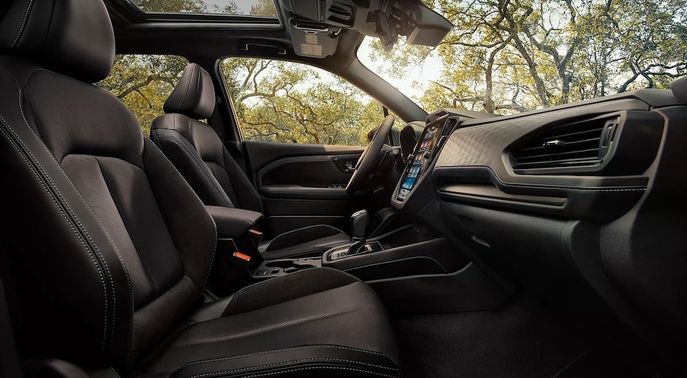 The black interior of a 2025 Subaru Forester is shown from the passenger side.