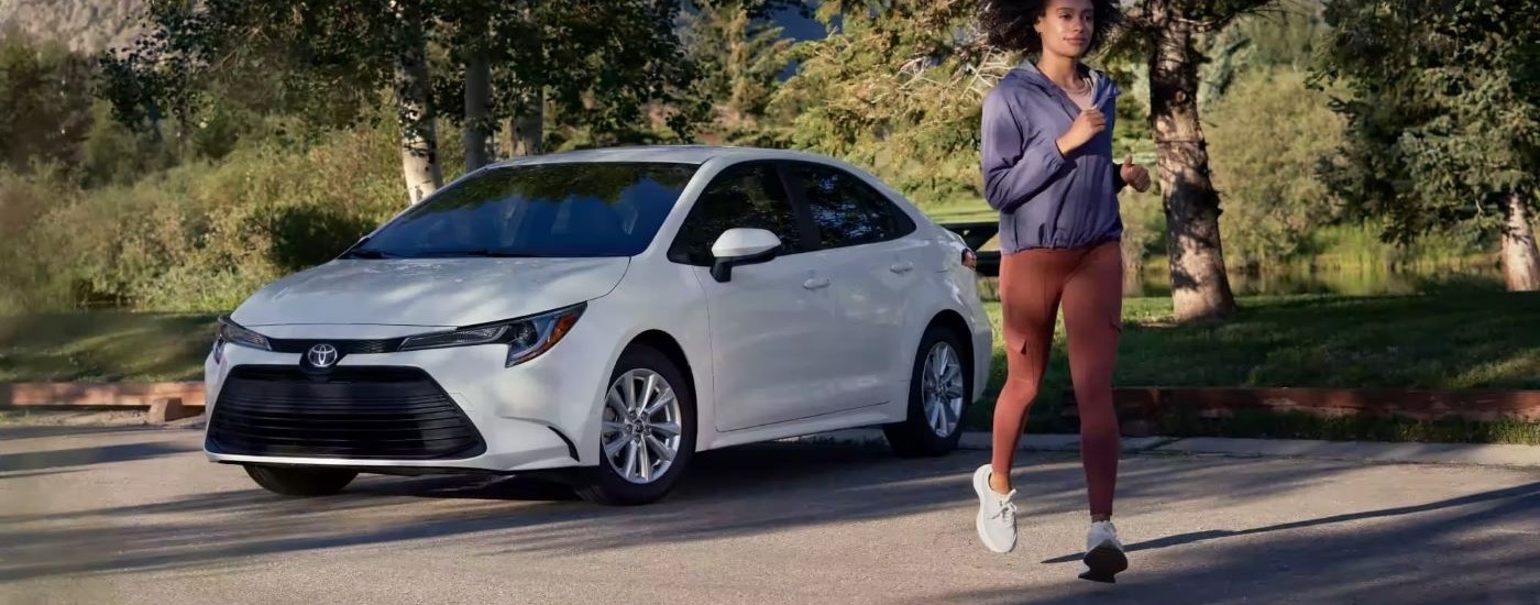 A white 2023 Toyota Corolla LE is shown parked in an open lot after leaving a Toyota dealer near White Plains, NY.