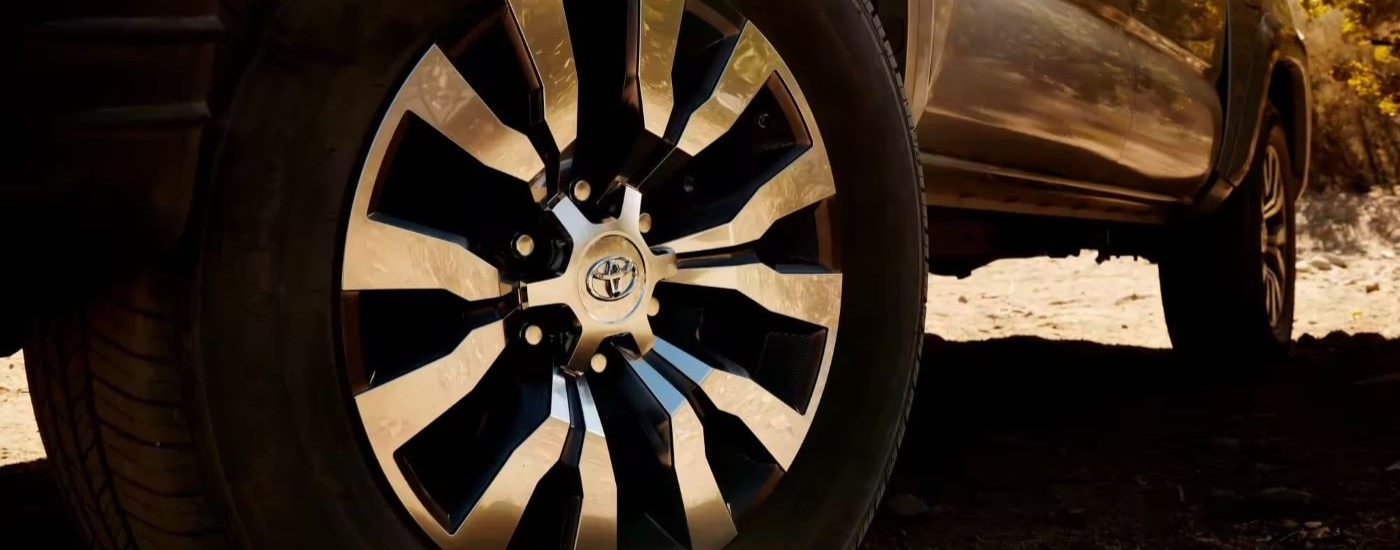 A close up shows the chrome rim on a 2022 Toyota Tacoma Limited.