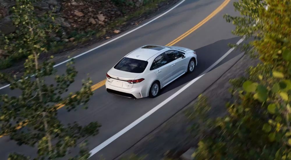 A white 2023 Toyota Corolla SE is shown from the rear at a high angle after leaving a Toyota dealer in Yonkers.