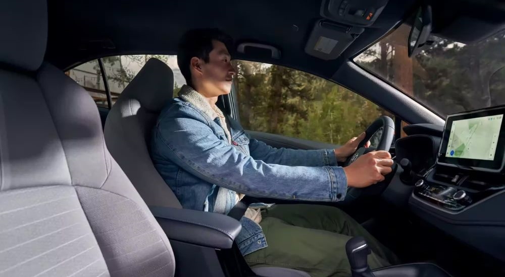 The black interior of a 2023 Toyota Corolla is shown from the passenger seat.