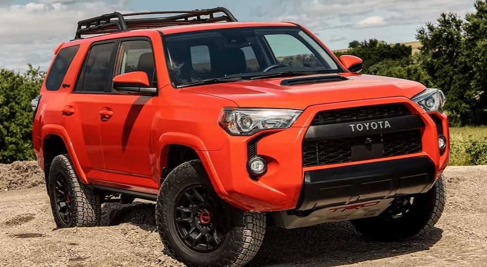 A popular used Toyota for sale, an orange 2023 Toyota 4Runner TRD Pro, is shown parked off-road.