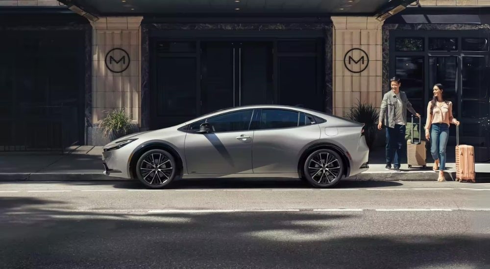 A silver 2023 Toyota Prius is shown from the side on a city street after leaving a Toyota dealer near Ardsley.