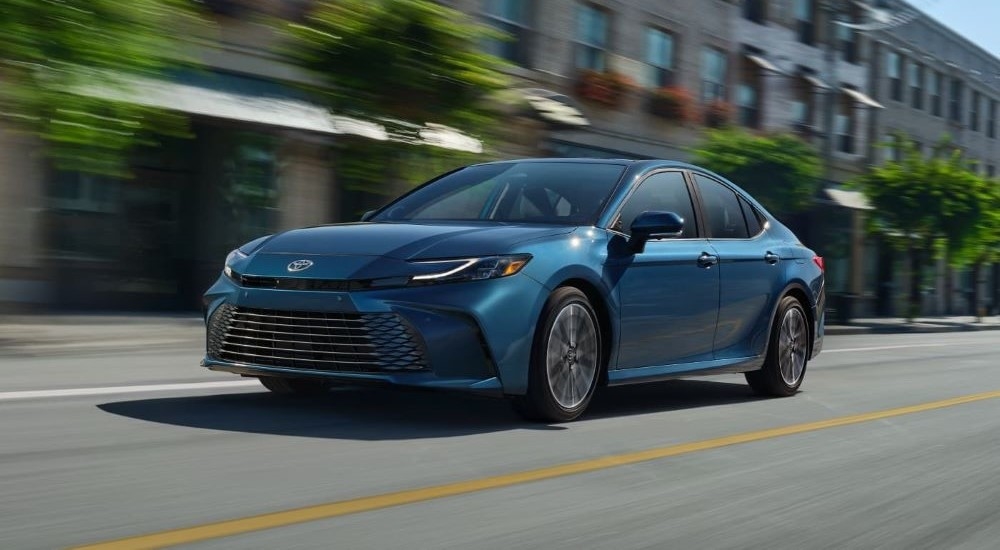 A blue 2025 Toyota Camry XLE is shown from the front at an angle.