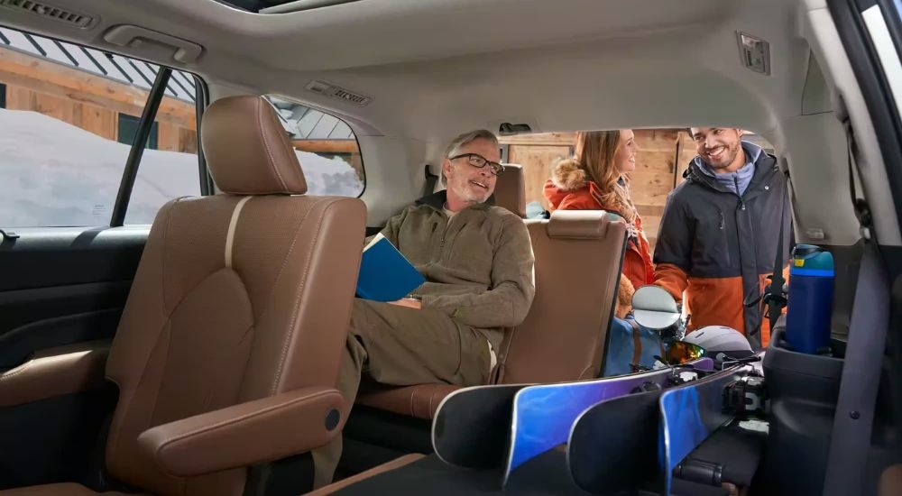 Three rows of brown leather seating in a 2024 Toyota Grand Highlander Platinum.