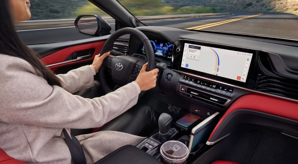 The infotainment screen and red upholstery in a 2025 Toyota Camry XSE for sale.