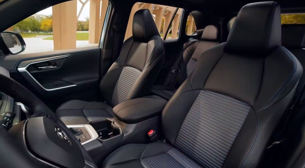 The black interior of a used 2023 Toyota RAV4 for sale.