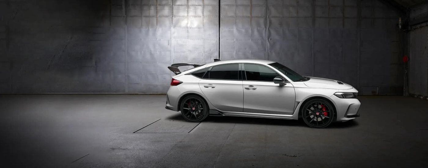 A white 2024 Honda Civic Type R is shown parked in a garage.