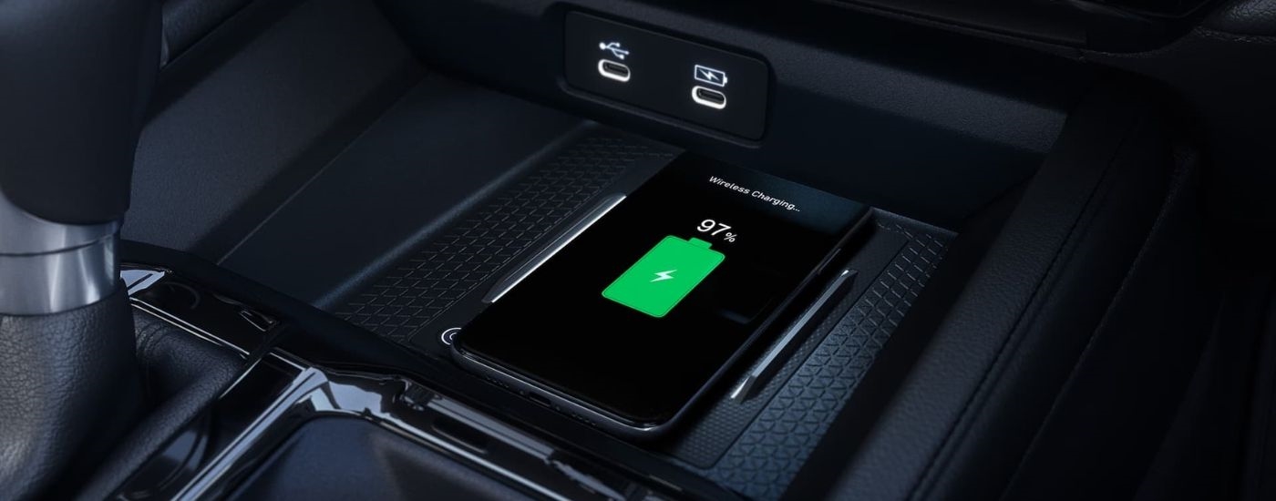 A close-up shows a phone charging in a 2024 Honda Accord.