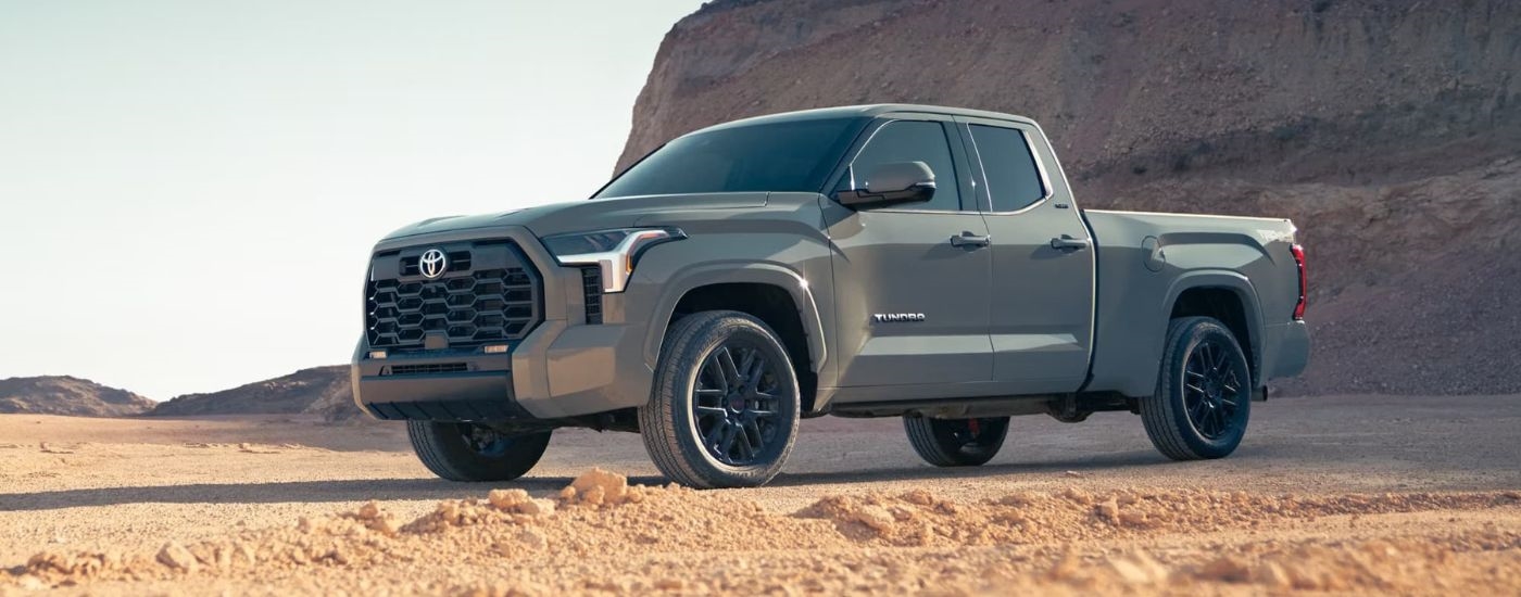 A grey 2024 Toyota Tundra SR5 TRD Sport is shown parked off-road.