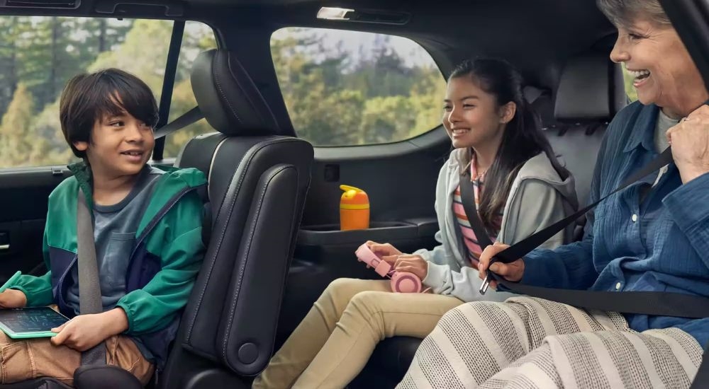 People are shown in a 2024 Toyota Grand Highlander.