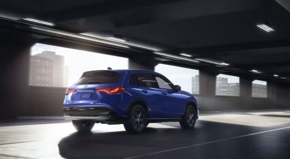 A blue 2025 Honda HR-V is shown driving through a tunnel after looking at cars for sale.