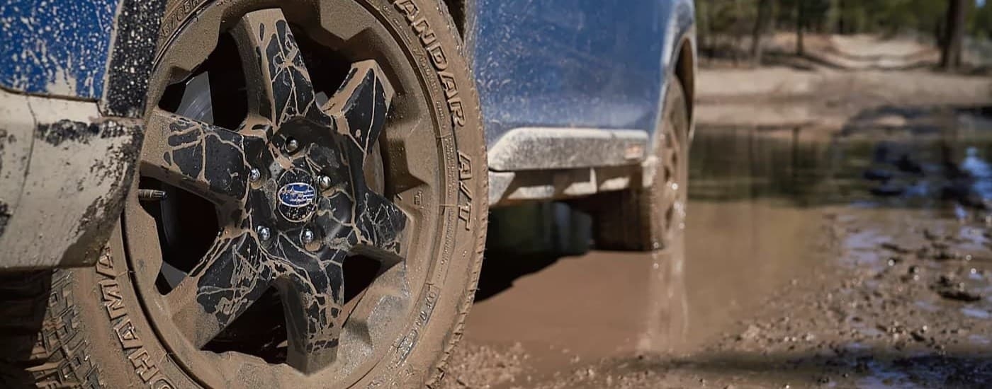 A close-up on the wheels of a blue 2024 Subaru Outback Wilderness.