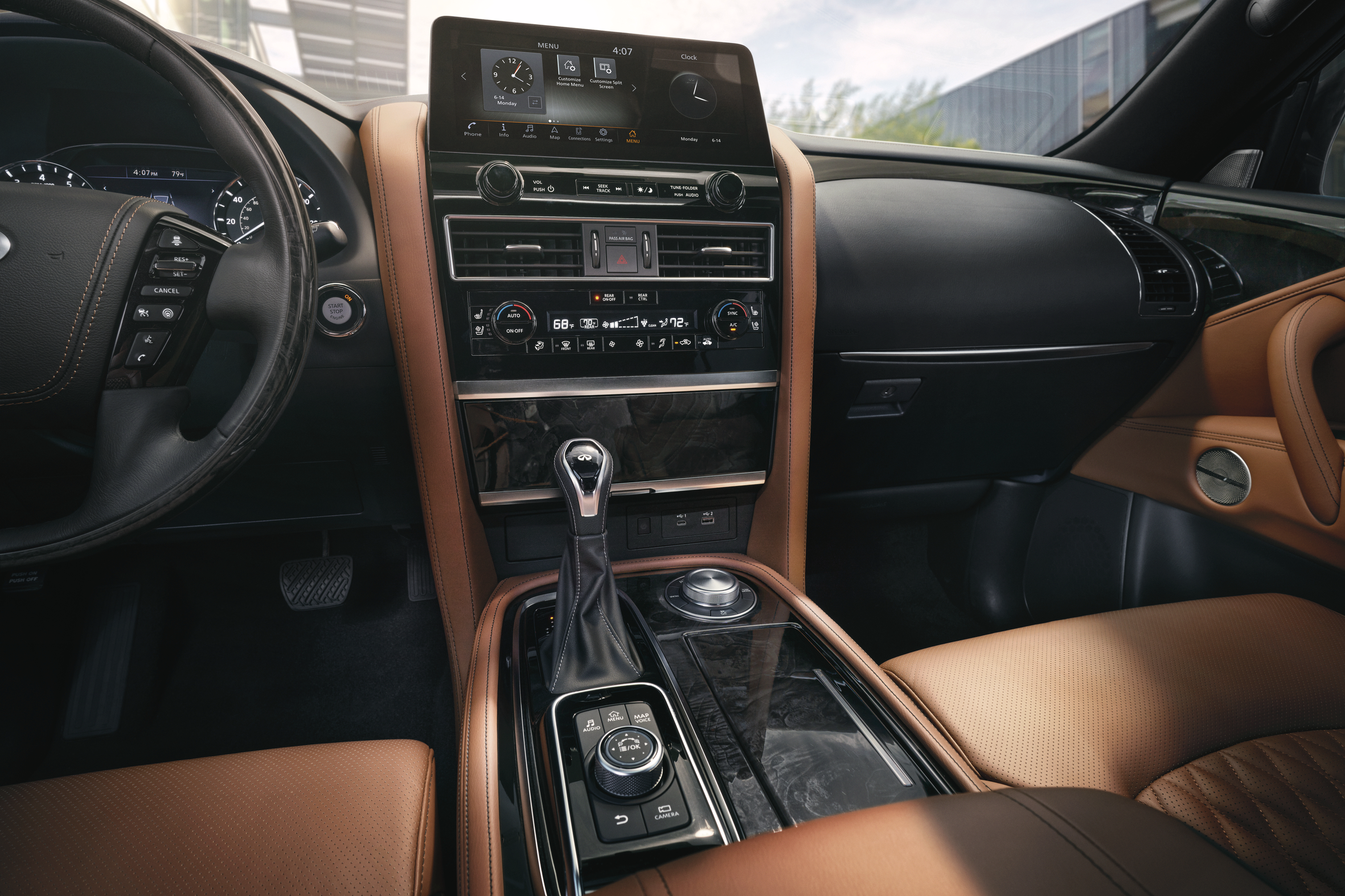  Interior view of the 2023 Infiniti QX80 showcasing the luxury dashboard, touchscreen display, and leather finishes in Denver.