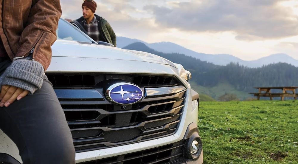 A close-up on the grille of a white 2024 Subaru Outback.