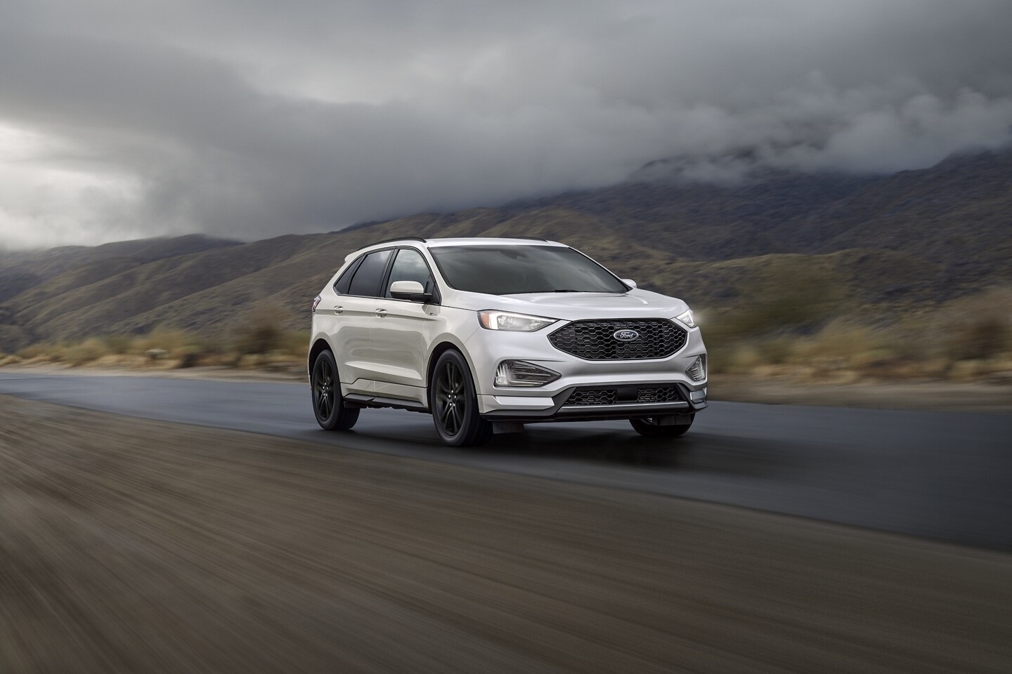 white 2024 Ford Edge driving down a road