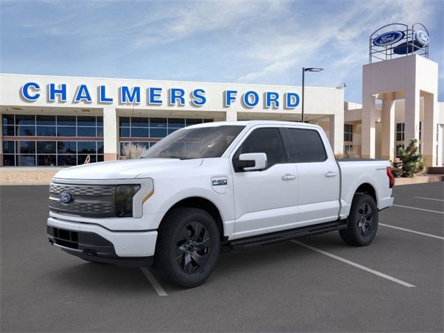 white 2024 Ford F-150 Lightning electric truck parked at the Chalmers Ford dealership in Albuquerque, NM