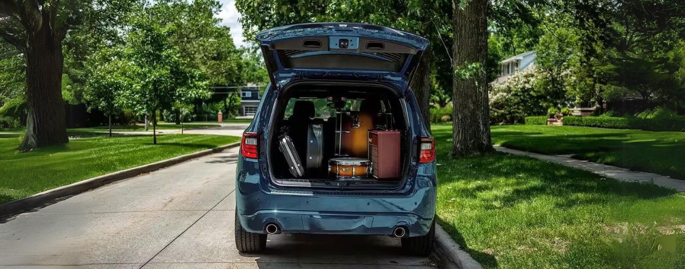 Music equipment is shown in the trunk of a 2023 Dodge Durango.