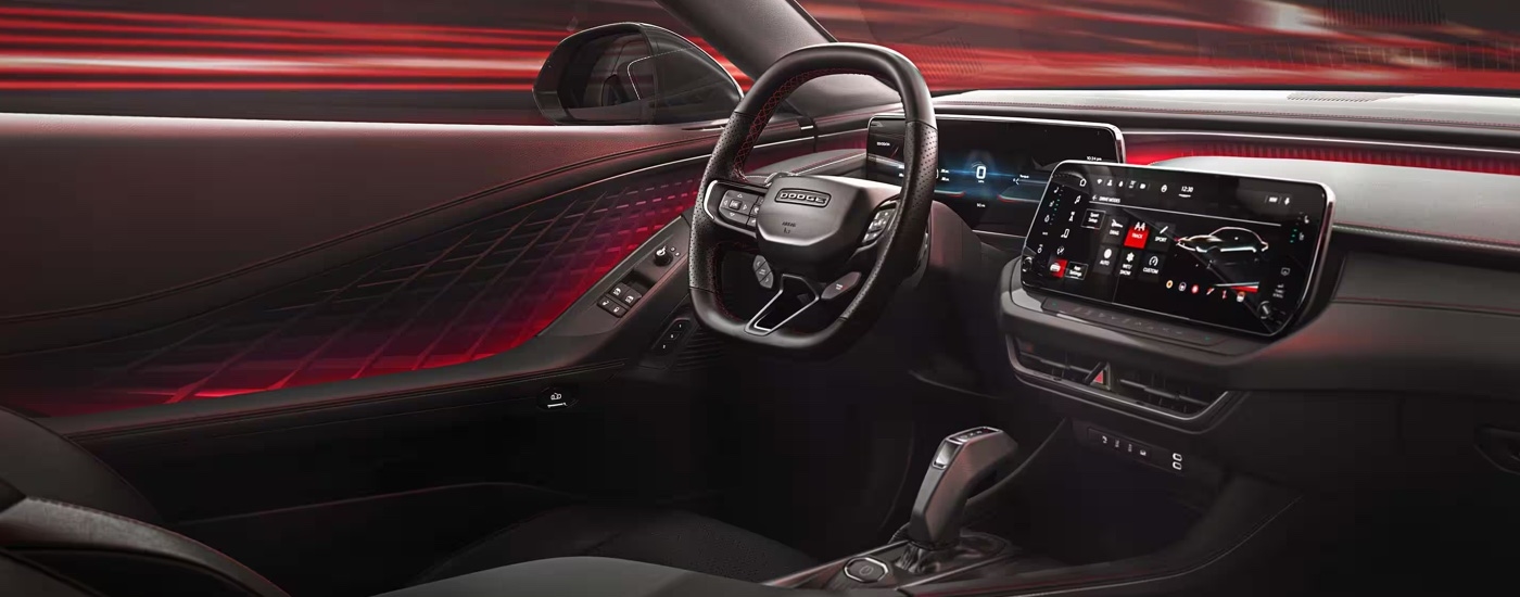 The red and black interior of a 2024 Dodge Charger Daytona at a Dodge dealer near Red Hook.