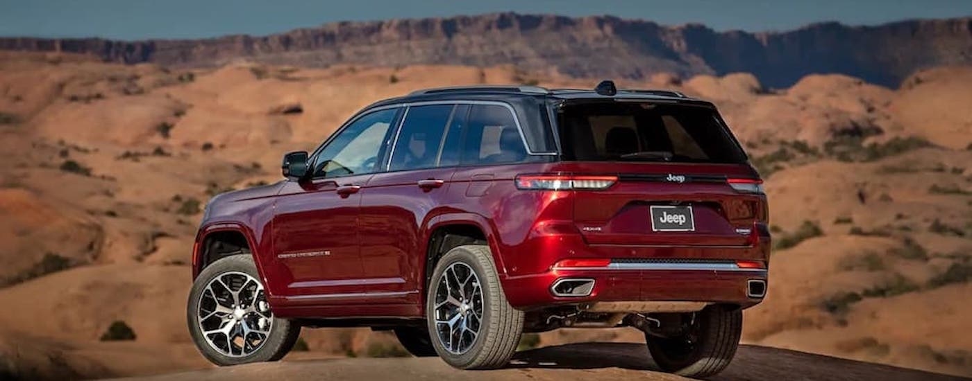 A red 2022 Jeep Grand Cherokee for sale is shown from the rear at an angle.