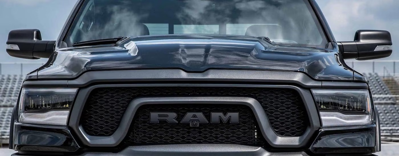 A black 2023 Ram 1500 Rebel is shown from the front at a Ram dealer near Poughkeepsie.