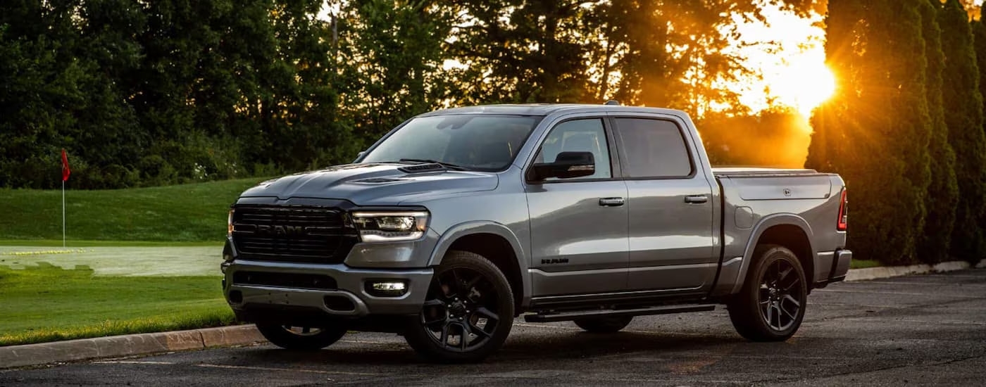 A grey 2022 Ram 1500 is shown parked in an empty parking lot.