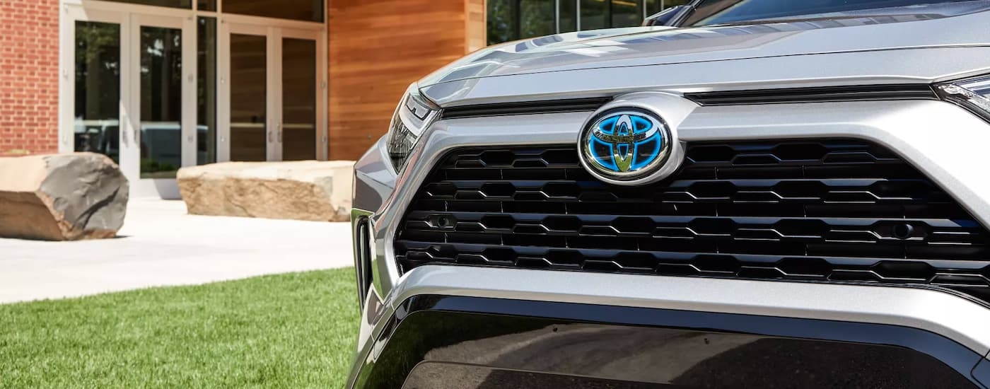 A close-up on the grille of a grey 2024 Toyota RAV4 Hybrid XSE.