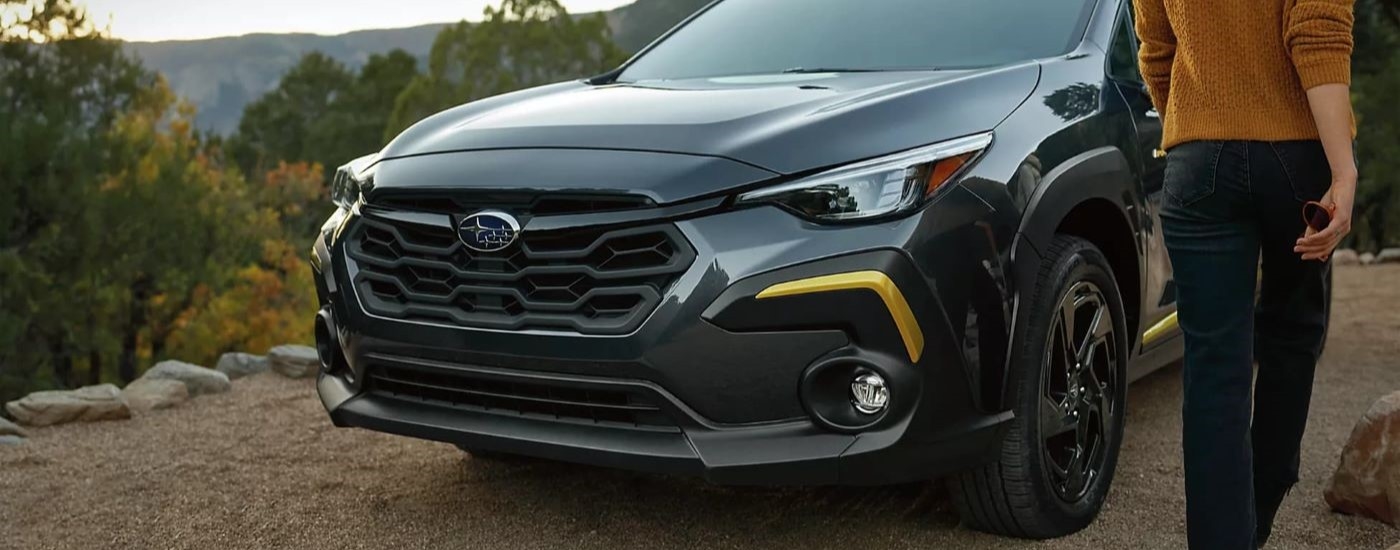 Close-up on the grille of a black 2024 Subaru Crosstrek Sport.