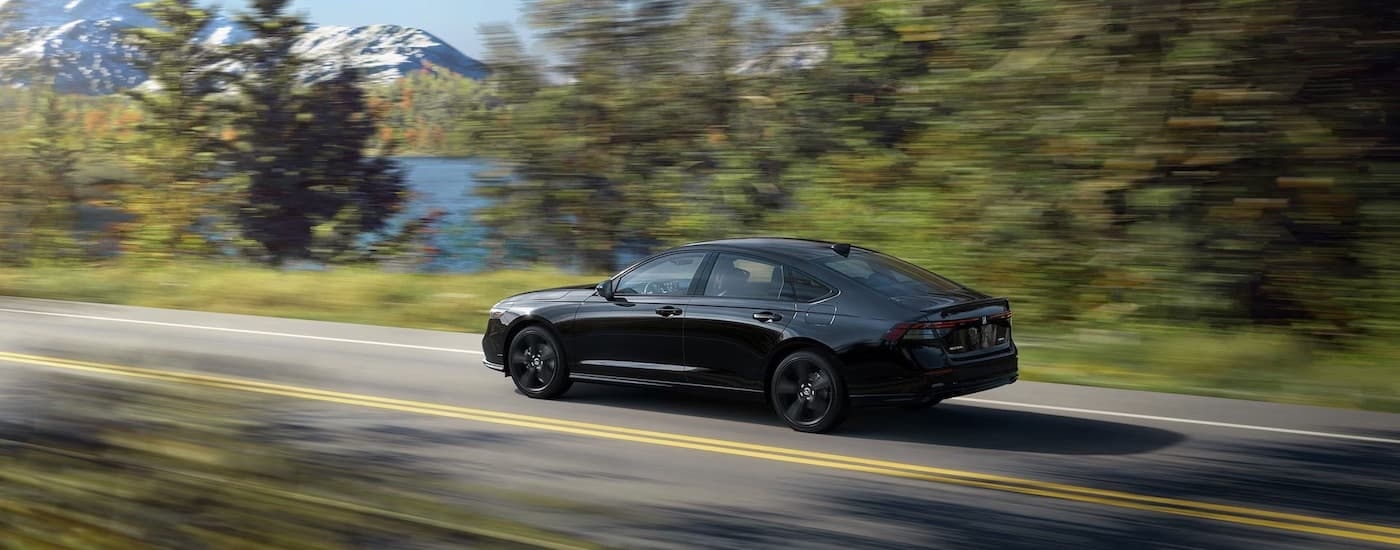 A black 2023 Honda Accord is shown from the rear at an angle after leaving a Honda dealer near Mahwah.