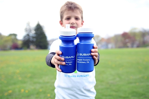 Boy holding water bottles at Roxbury Park