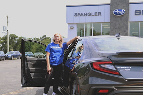 AAABA Ambassador posing with a 2024 Subaru WRX