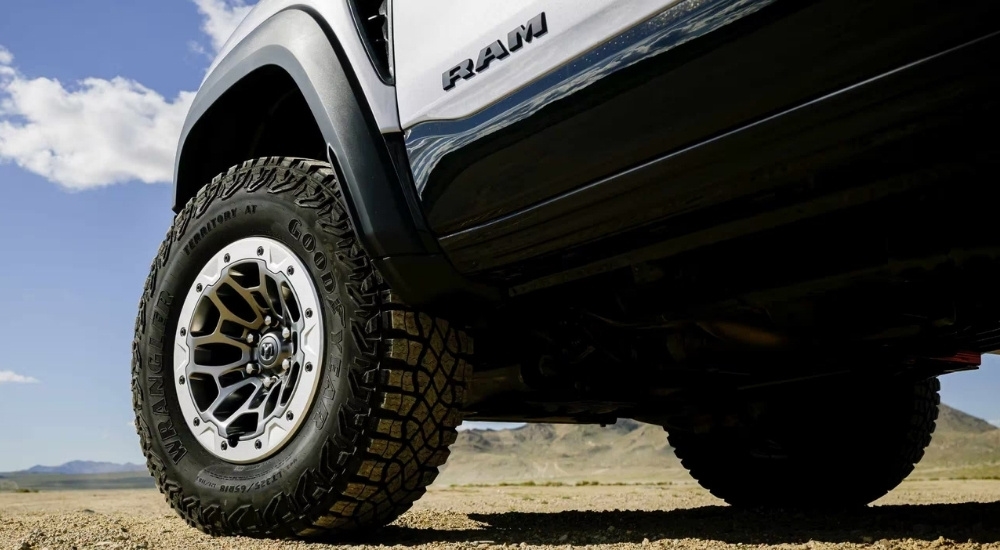 A close up shows the front driver side wheel on a silver 2025 Ram 1500 RHO.