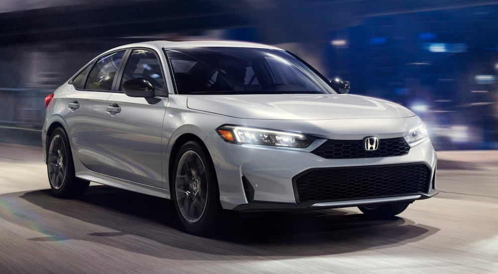 A white 2025 Honda Civic driving through a tunnel.