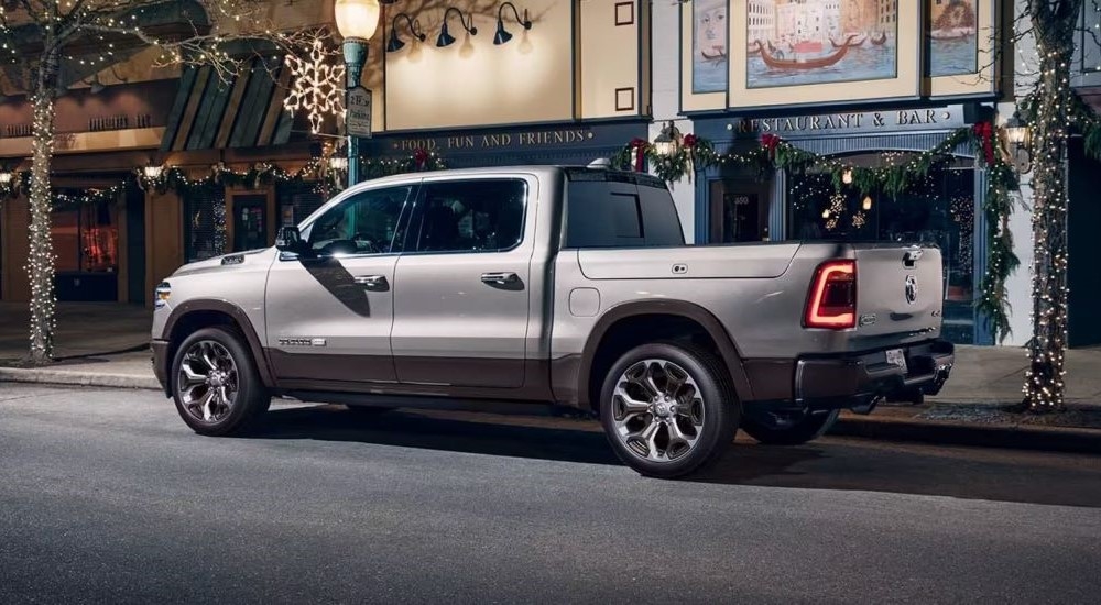 A tan 2020 Ram 1500  is shown parked in front of a restaurant.