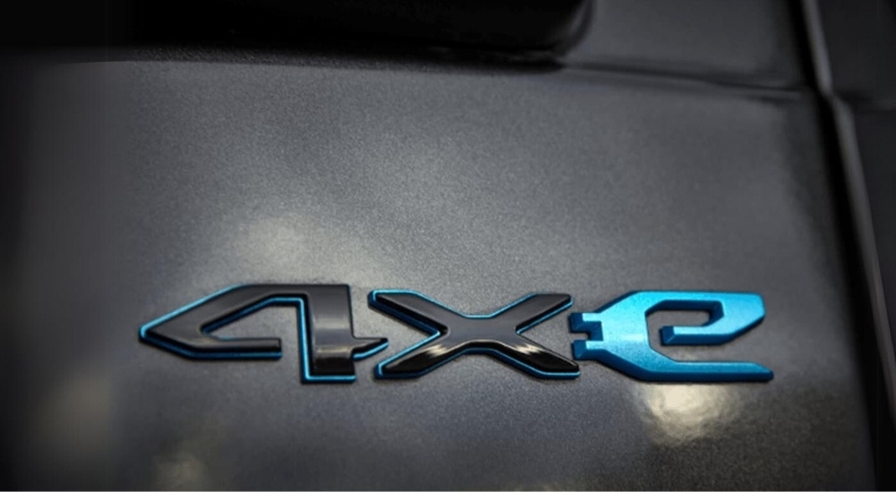 A close up shows the 4xe bagde on a grey 2024 Jeep Wrangler 4xe.