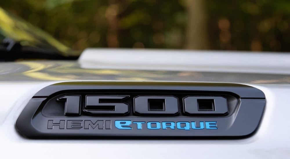 A close up shows the 'eTorque' badge on a silver 2023 Ram 1500 Big Horn BackCountry.