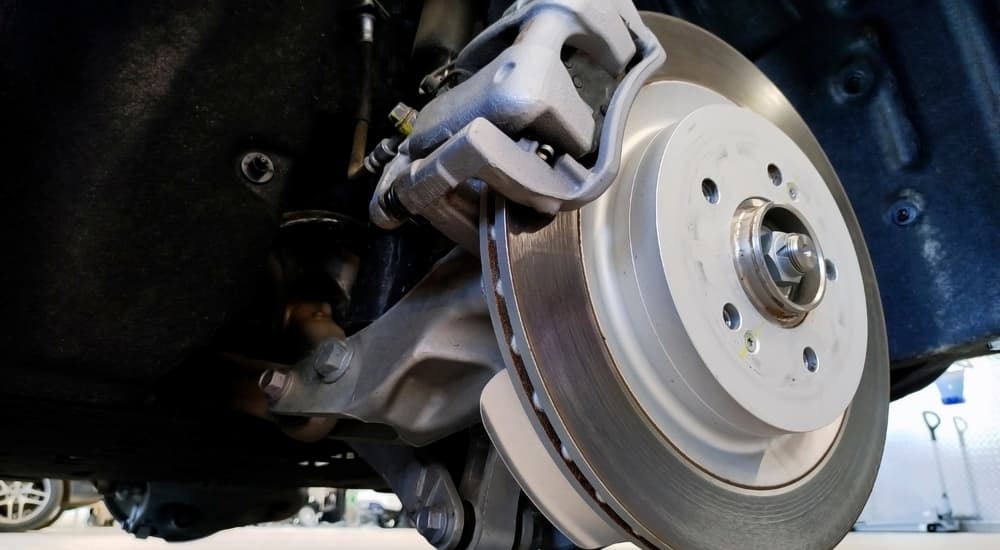 A close-up of a brake under a car.