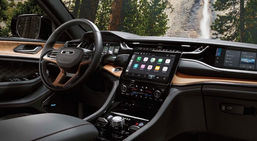 The black and wood grain interior is shown in a 2024 Jeep Grand Cherokee 4xe.