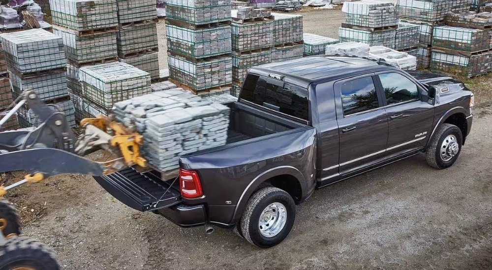 Blocks are shown being loaded in the bed of a grey  2024 Ram 3500.