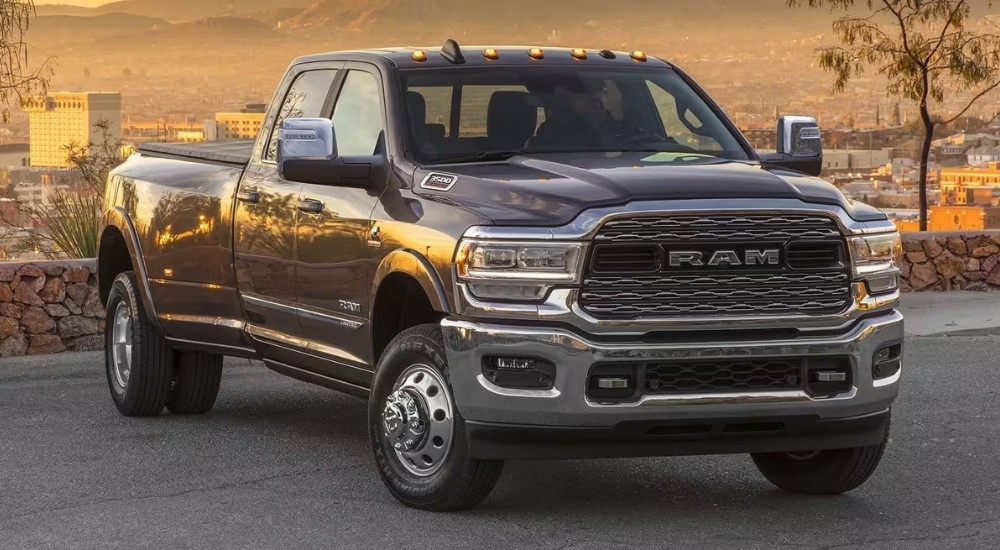 A grey 2024 Ram 3500 for sale is shown parked on pavement.