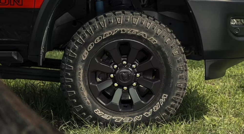 A close-up shows a wheel on a red  2024 Ram 2500.