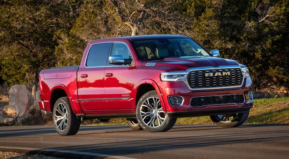 A red 2025 Ram 1500 Tungsten is shown parked on pavement.