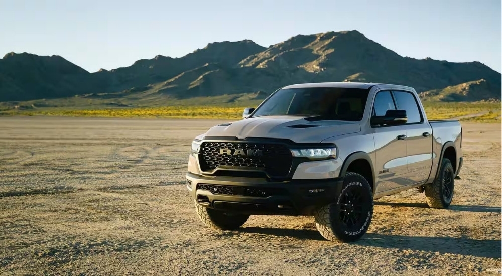 A silver 2025 Ram 1500 Rebel X is shown off-road after shopping for Ram trucks for sale.