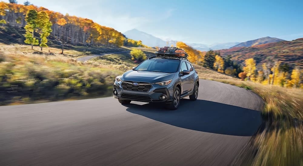 A grey 2024 Subaru Crosstrek Premium is shown from the front at an angle.