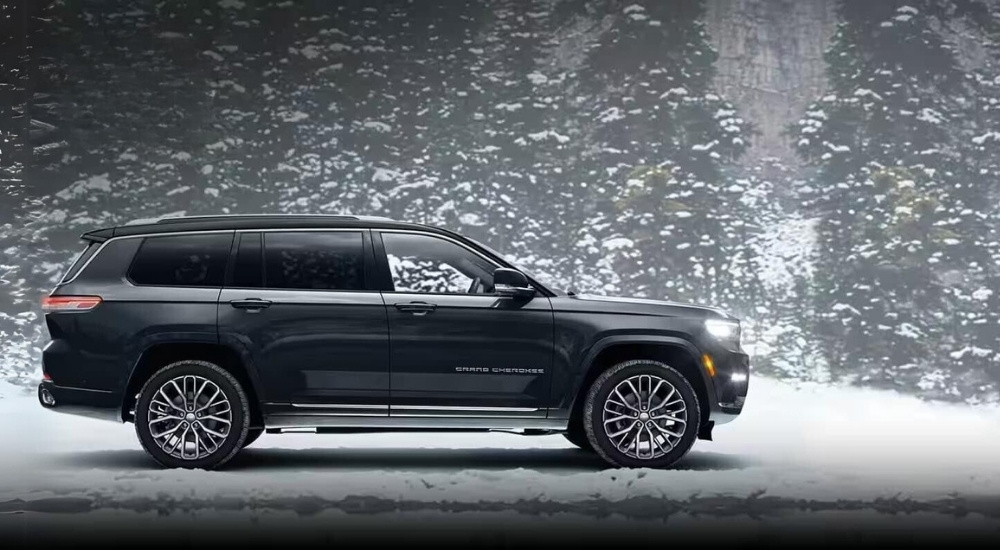 A grey 2024 Jeep Grand Cherokee for sale is shown parked on snow.