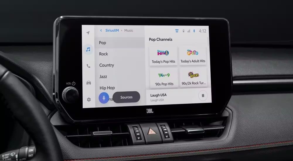 Close-up on the dashboard screen in the black interior of a 2024 Toyota RAV4.